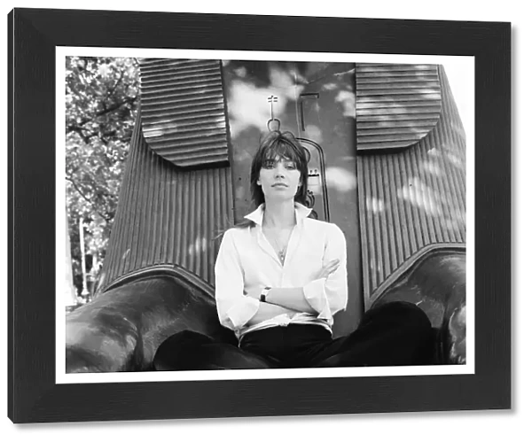 Francoise Hardy, french singer pictured seated between the feet of a sphinx