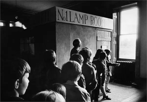A party of schoolchildren wait their turn to enter the 'pit'