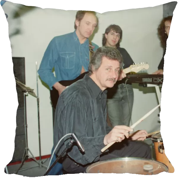 Pete Best, (in the black shirt holding his drum sticks) posing for the camera with his