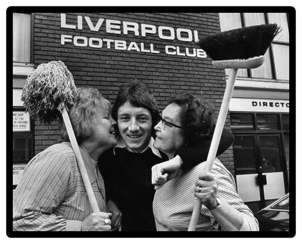 Liverpool footballer Jimmy Case gets an extra special welcome from two workers at Anfield