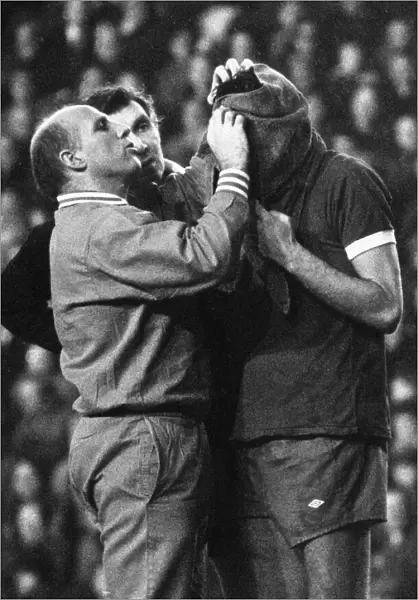 Liverpool trainer Ronnie Moran attends to John Toshack who has received a nasty cut