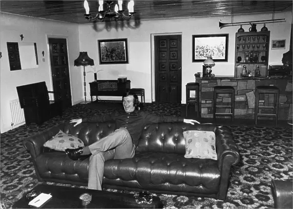Liverpool footballer Tommy Smith at home on his sofa. 19th December 1973
