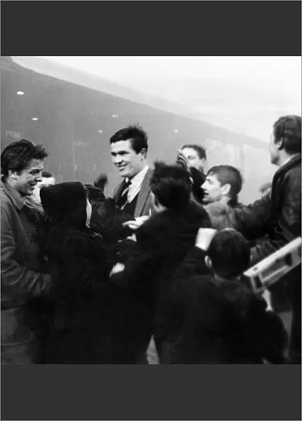 Liverpool captain Ron Yeats is surrounded by worshipping fans who have run on to