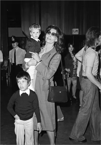 Italian actress Sophia Loren and her two children leaving Heathrow Airport for Rome