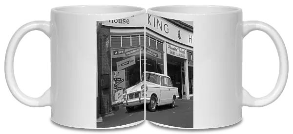A new Triumph Herald leaves the showrooms of King and Harper on Milton Road Cambridge May