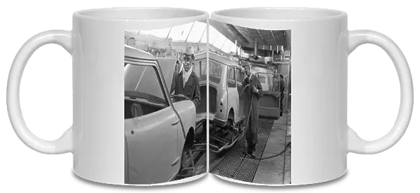 Austin Mini body shells are spray painted in the paint shop on production line at