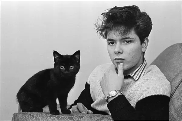 Portrait of rock and roll singer Cliff Richard with a cat. 3rd January 1959