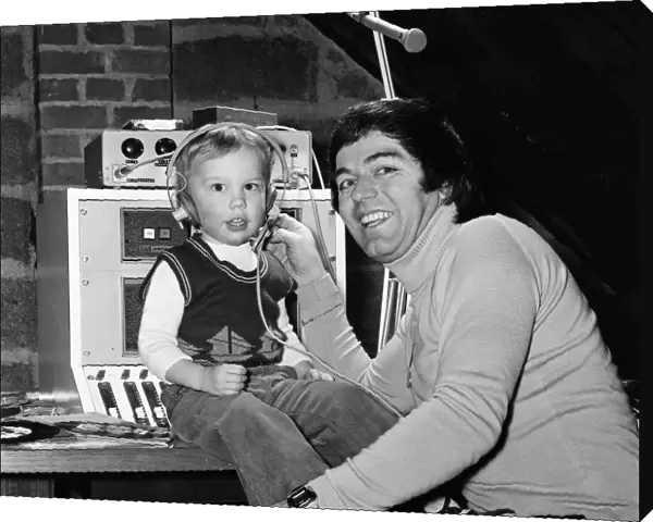 Disc Jockey Tony Blackburn and his son Simon, 3, in their private recording studio in