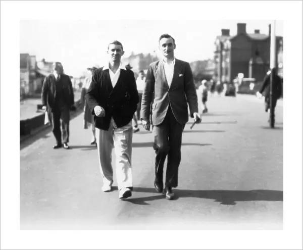 Two men walking along the seafront at Teignmouth, Devon. 1930. Tyrell Collection