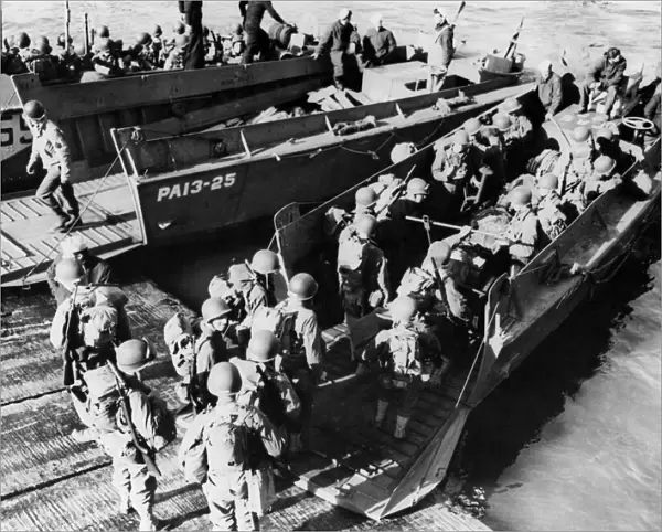This picture shows American troops going aboard a landing craft during the successful