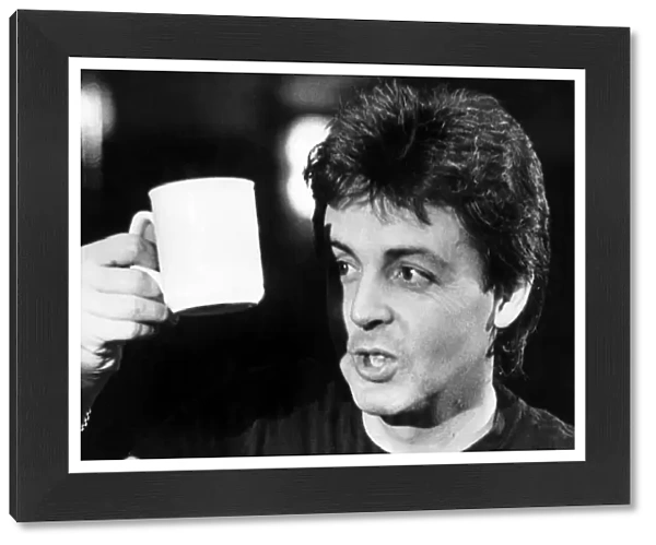 Paul McCartney pictured relaxing with a cup of tea, after the Wings concert at The