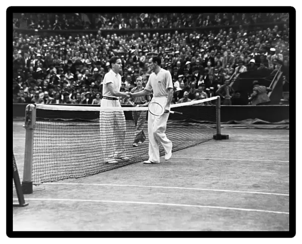 Fred Perry (right) and Gottfried von Cramm (left) of Germany shake hands at the net after