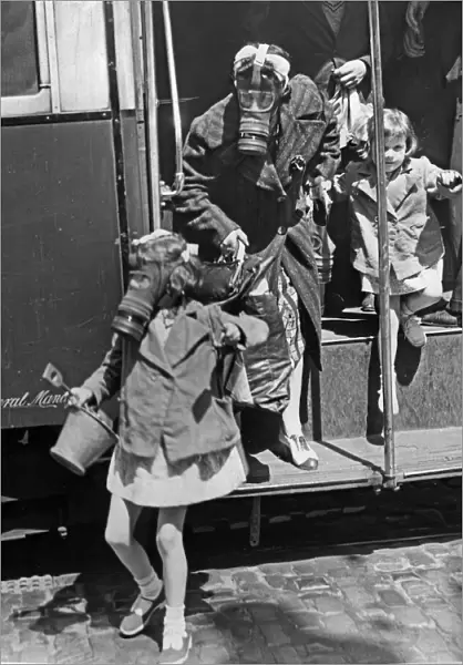 Passengers disembark from a bus wearing their gas masks during an ARP exercise