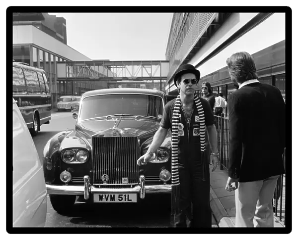Elton John, pictured with his Rolls Royce. On his arrival from a recording session in Los