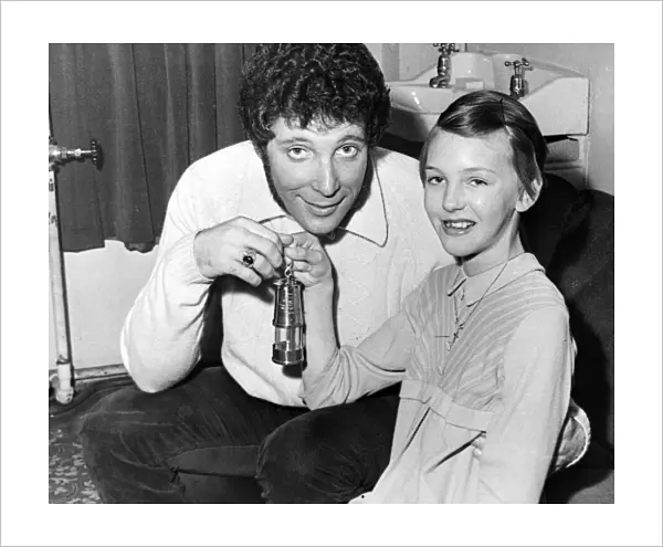 Jayne King, aged 11, presents a miners lamp to Tom jones at the Capitol Theatre, Cardiff