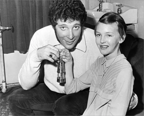 Jayne King, aged 11, presents a miners lamp to Tom jones at the Capitol Theatre, Cardiff