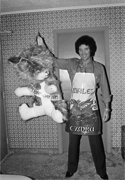 Tom Jones poses with presents from fans at Westbury Music Festival, just outside New York