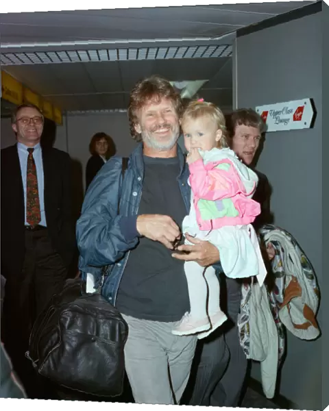 Members of The Highwaymen at Heathrow Airport. Kris Kristofferson and children