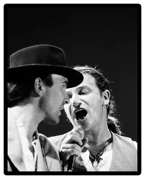 Bono onstage singing with The Edge during U2s concert in Cork