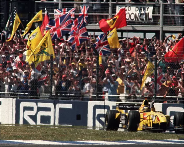 Damon Hill at the British Grand Prix July 1999 waves to the crowd at the end of