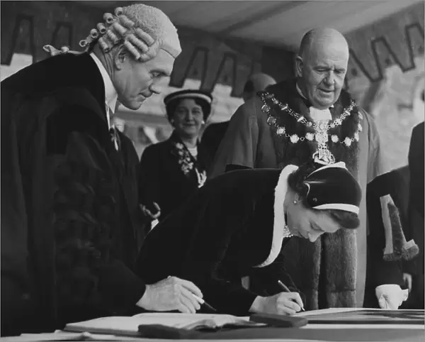 The Queen autographing one of the Royal Portraits at Morecambe with the Mayor Bryce Clegg