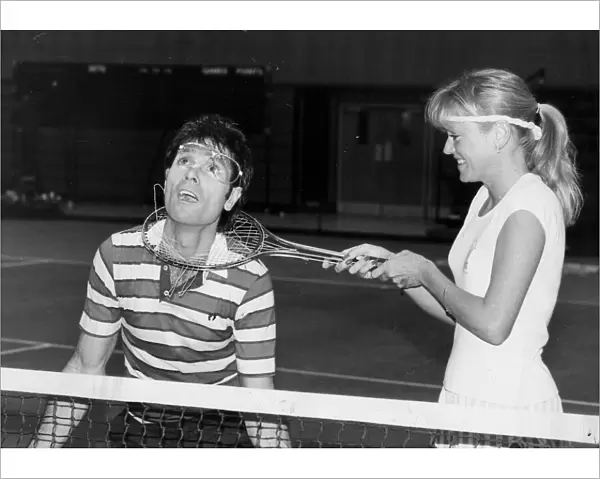 Sue Barker fooling around with Cliff Richard at doubles tennis match - December 1986