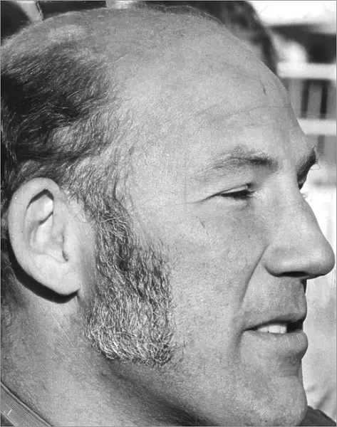 Stirling Moss in profile serious during interview at track - December 1971