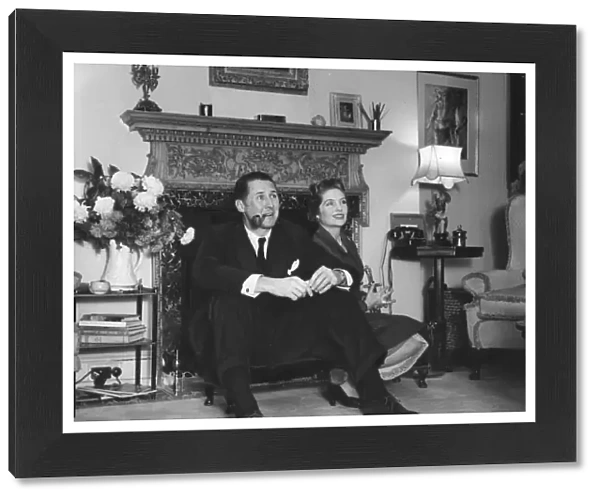 Anthony Quayle and wife Dorothy Hyson sitting by fire place of their London home - 24