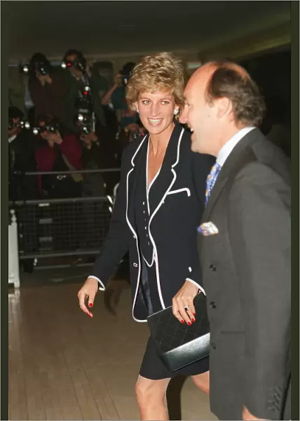PRINCESS DIANA, SMILING, AND AN UNKNOWN MAN ARRIVE AT A FUNCTION - 05  /  06  /  1995
