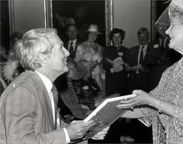 ERNIE WISE RECIEVES A COMMENDATION FROM THE QUEEN MOTHER FOR HIS WORK IN THE