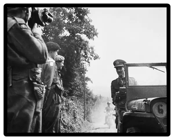 Lieut. Gen. M. C Dempsey, O. B. E M. C (in jeep) talking to Major the Marquis of Hartington