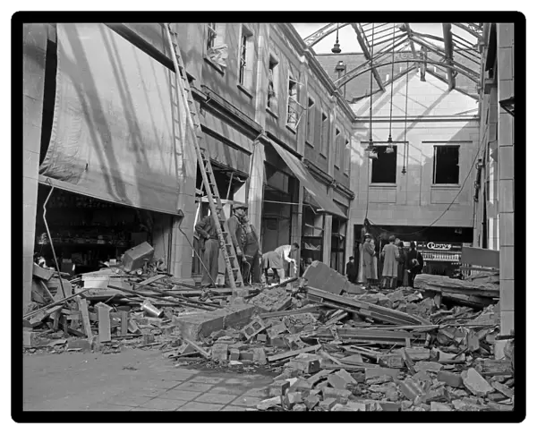 Workmen inspect the damage to The Arcade in Coventry following a raid on the city