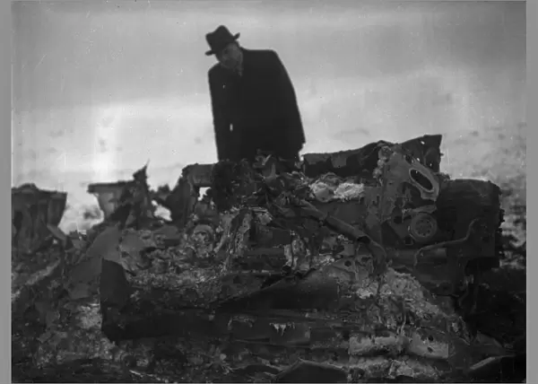 A member of the air Intelligence branch of the war office inspect the wreckage of a