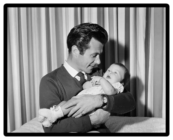 Bryan Forbes with his baby daughter Sarah Kate, at their home in Virginia Water, Surrey