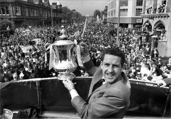 Dave Mackay of Tottenham Hotspur parades the FA Cup down the High Street in Tottenham