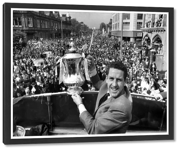 Dave Mackay of Tottenham Hotspur parades the FA Cup down the High Street in Tottenham