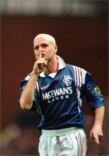 Paul Gascoigne of Rangers Football Club with his finger up to his mouth making a sign to