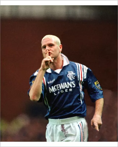 Paul Gascoigne of Rangers Football Club with his finger up to his mouth making a sign to