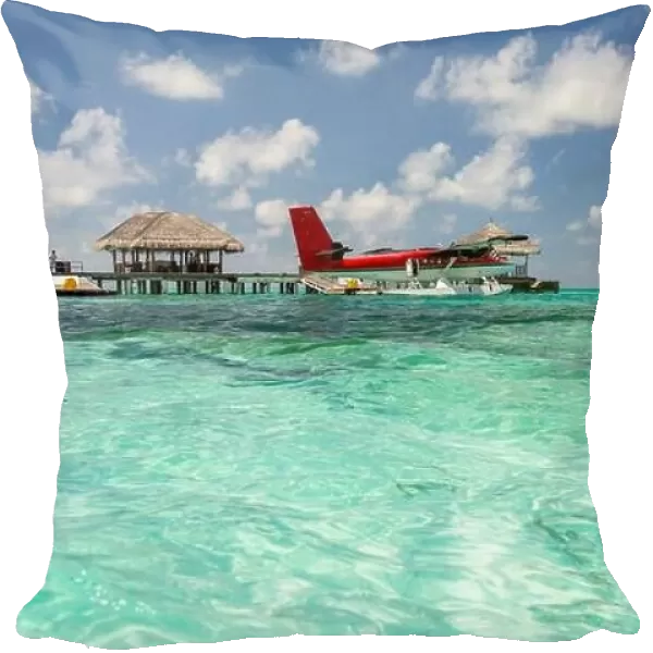 Seaplane at Maldives islands. Amazing blue lagoon, with red seaplane. Luxury travel and summer vacation concept