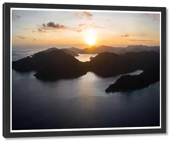 The sun rises over the amazing islands of Raja Ampat, Indonesia. This remote, tropical region is known for its extremely high marine biodiversity