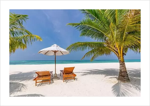 Beautiful tropical beach, two sun beds, loungers, umbrella under palm tree. White sand, sea view horizon, blue sky, calmness and relax resort scenery