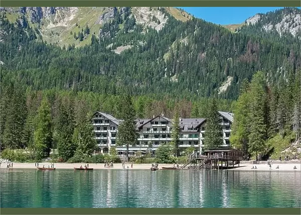 Braies, Italy - 21 August 2022: Hotel on Lake Braies, in the Dolomites Alps, among the green forest and mountains