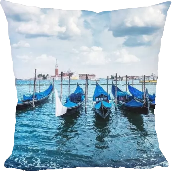 Colorful landscape with clear blue sky on piazza San Marco in Venice. Row of gondolas parked on city pier