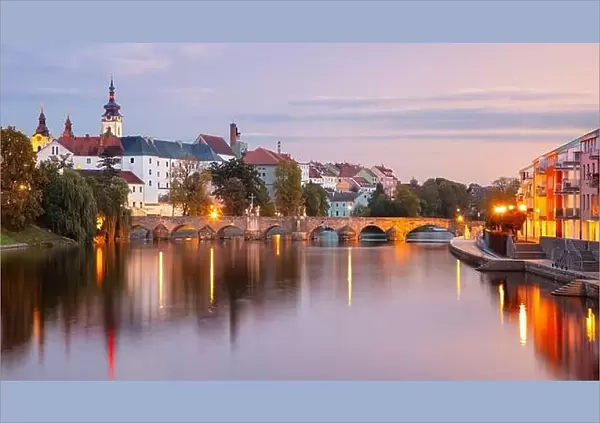 Pisek, Czech Republic. Panoramic cityscape image of Pisek with famous Stone Bridge at beautiful autumn sunset