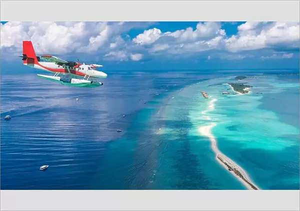 Aerial view of a seaplane approaching island in the Maldives. Maldives beach from birds eye view. Aerial view on Maldives island, atolls and blue sea
