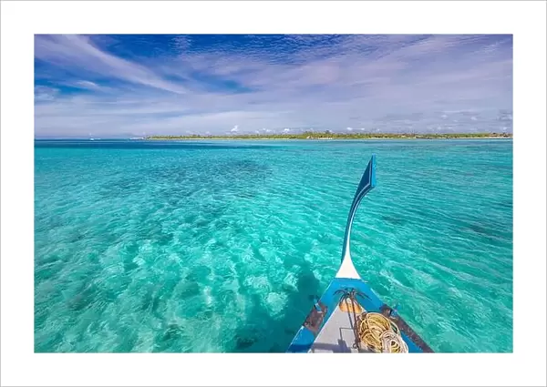 Traditional Maldivian boat Dhoni with amazing tropical island background view. Nature paradise beach, open sea view, seascape in Maldives, luxury