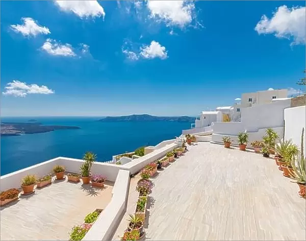 Beautiful terrace in Santorini with breathtaking view. Flowers pots with picturesque view of traditional cycladic Santorini houses