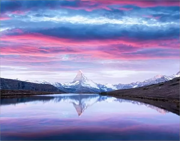 Magic landscape with colorful sunrise on Stellisee lake. Snowy Matterhorn Cervino peak with reflection in clear water. Zermatt, Swiss Alps
