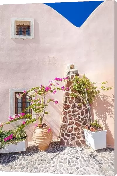 Traditional famous white blue houses wih flowers under sunny weather over the Caldera, Aegean sea. Beautiful summer landscape, sea view, luxury travel