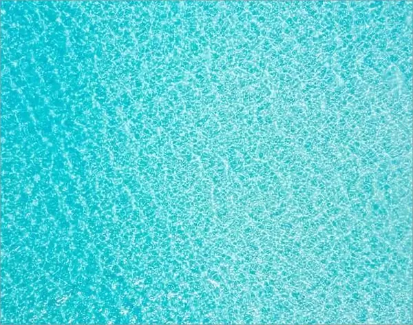 Sea from above drone view. Blue sea surface, top view. Amazing nature ocean pattern, shallow lagoon, tropical water. Relaxing natural environment